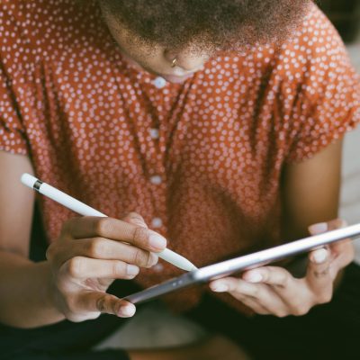 Photo of Person Holding Tablet
